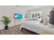 Spacious main bedroom with wood floors, and a flatscreen TV for entertainment at 5101 Huntington Ne Cir, St Petersburg, FL 33703