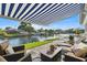 Covered patio with comfortable seating, offering serene views of the waterfront and boat docks at 5101 Huntington Ne Cir, St Petersburg, FL 33703