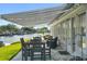 Outdoor patio with dining and lounging area, featuring a retractable awning and waterfront view at 5101 Huntington Ne Cir, St Petersburg, FL 33703