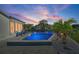 Sparkling pool at dusk with a serene waterfront view, complemented by tasteful landscaping and relaxing lounge chairs at 5101 Huntington Ne Cir, St Petersburg, FL 33703