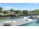 Inviting waterfront pool with lounge chairs, tranquil water features, and lush landscaping, perfect for relaxation at 5101 Huntington Ne Cir, St Petersburg, FL 33703