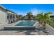 Inviting waterfront pool area with outdoor seating, lush landscaping, and direct canal access at 5101 Huntington Ne Cir, St Petersburg, FL 33703