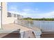 Spacious balcony with water views, white railing, and outdoor furniture at 6475 Shoreline Dr # 5105, St Petersburg, FL 33708