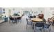 Community room with tables, chairs, piano, and TV at 6475 Shoreline Dr # 5105, St Petersburg, FL 33708