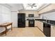 Bright kitchen with black appliances and wood cabinets at 6475 Shoreline Dr # 5105, St Petersburg, FL 33708