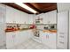 White kitchen with red accents, modern appliances, and ample counter space at 6580 10Th Avenue S Ter, St Petersburg, FL 33707