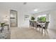 Casual dining area with grey chairs and access to the kitchen and patio at 704 N Castle Ct, Tampa, FL 33612