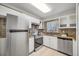 Modern kitchen with stainless steel appliances and tile backsplash at 704 N Castle Ct, Tampa, FL 33612