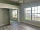 Bedroom with sliding mirror closet doors and large windows at 7129 Melrose Pl, Bradenton, FL 34203