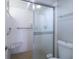 Neutral bathroom with tiled shower, glass door, and built-in seat at 7400 Sun Island Dr # 501, South Pasadena, FL 33707