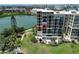 Luxury high-rise with a beautiful view of the water, manicured lawn, and mature palm trees in a desirable coastal location at 7400 Sun Island Dr # 501, South Pasadena, FL 33707