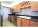 Well-equipped kitchen with stainless steel appliances, wood cabinets, and granite countertops at 7400 Sun Island Dr # 501, South Pasadena, FL 33707