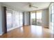 Bright living room with hardwood floors, balcony access, and scenic views at 7400 Sun Island Dr # 501, South Pasadena, FL 33707