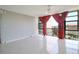 Bright living room with tile floors and access to a balcony with scenic views at 7400 Sun Island Dr # 501, South Pasadena, FL 33707
