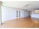 Spacious living room with wood floors, a ceiling fan, and a door leading to a balcony at 7400 Sun Island Dr # 501, South Pasadena, FL 33707