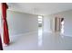 Open-concept living room with tile floors, a large window, and a door leading to a balcony at 7400 Sun Island Dr # 501, South Pasadena, FL 33707