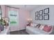 Charming pink bedroom with a daybed, perfect for a or guest room at 744 Steel Dr, Apollo Beach, FL 33572