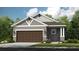 Charming single-story home with a brown garage door, gray siding, and white trim at 744 Steel Dr, Apollo Beach, FL 33572