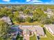 Aerial view of a community with a focus on a charming villa-style home with a two-car garage at 7497 Heather Walk Dr, Weeki Wachee, FL 34613