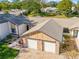 An aerial view of a two-unit villa with a shared driveway and two-car garage at 7497 Heather Walk Dr, Weeki Wachee, FL 34613