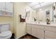 Second bathroom with vanity, toilet, and wall-mounted shelving at 7497 Heather Walk Dr, Weeki Wachee, FL 34613