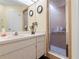Bathroom with single sink vanity, shower, and mirror at 7497 Heather Walk Dr, Weeki Wachee, FL 34613