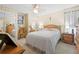 Spacious bedroom with a queen bed and mirrored closet doors at 7497 Heather Walk Dr, Weeki Wachee, FL 34613