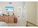 Main bedroom with dresser, TV, and access to hallway and bathroom at 7497 Heather Walk Dr, Weeki Wachee, FL 34613