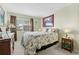 Cozy bedroom with a full-size bed, dresser, and views from the window at 7497 Heather Walk Dr, Weeki Wachee, FL 34613