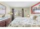 Bright bedroom with a queen bed and views of the backyard at 7497 Heather Walk Dr, Weeki Wachee, FL 34613
