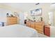 Bright bedroom with wood furniture and a large TV at 7497 Heather Walk Dr, Weeki Wachee, FL 34613