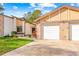 Two-car garage with brick facade and paved driveway at 7497 Heather Walk Dr, Weeki Wachee, FL 34613