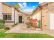 Front entry of home with walkway, landscaping, and decorative pot at 7497 Heather Walk Dr, Weeki Wachee, FL 34613