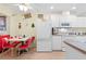 Kitchen with white cabinets, and retro-style dinette set at 7497 Heather Walk Dr, Weeki Wachee, FL 34613