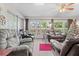 Sunroom with leather furniture and view to backyard at 7497 Heather Walk Dr, Weeki Wachee, FL 34613