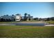 Community gathering area with a stage overlooking a grassy lawn, ideal for outdoor events and performances at 9710 Runaway Breeze Dr, Land O Lakes, FL 34637