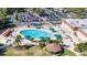 Aerial view of resort-style pool with surrounding lounge chairs and umbrellas at 2204 Grenadier Dr, Sun City Center, FL 33573