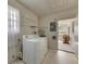 Bright laundry room with washer, dryer and access to sunroom at 2204 Grenadier Dr, Sun City Center, FL 33573