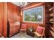 Sunroom with wood paneling, built-in shelving, and seating at 10708 Edgewater Ln, Tampa, FL 33612