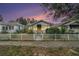 Charming bungalow with a white picket fence at sunset at 1115 Crescent Lake N Dr, St Petersburg, FL 33701