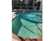 Close-up view of a pool with clear water, blue tiles, and brick coping at 11407 Gibralter Pl, Temple Terrace, FL 33617