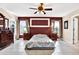 Spacious bedroom with ceiling fan, large windows, and ensuite bathroom access at 11835 Shrewsbury Ln, Parrish, FL 34219