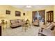 Living room with light walls, tiled floors and period furniture at 11835 Shrewsbury Ln, Parrish, FL 34219