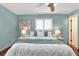 Spacious bedroom with ceiling fan, plush bedding, and stylish decor at 12288 Julia St, Seminole, FL 33772