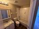 Well-lit bathroom featuring a shower-tub combo, white vanity with a marble countertop, and neutral wall colors at 1333 Misty Greens Dr, Sun City Center, FL 33573
