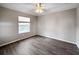 Simple bedroom with wood-look floors, natural light, and neutral paint at 1333 Misty Greens Dr, Sun City Center, FL 33573
