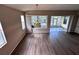 Open dining area with laminate floors, a unique pendant light, and views of the screened lanai at 1333 Misty Greens Dr, Sun City Center, FL 33573