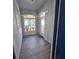Bright, enclosed entryway with tiled floors and glass block windows at 1333 Misty Greens Dr, Sun City Center, FL 33573