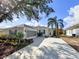Charming single-story home with mature landscaping, a large driveway, and a screened-in garage, perfect for Florida living at 1333 Misty Greens Dr, Sun City Center, FL 33573
