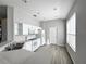Bright kitchen featuring white appliances, wood-look floors, plenty of cabinetry, and lots of natural light at 1333 Misty Greens Dr, Sun City Center, FL 33573